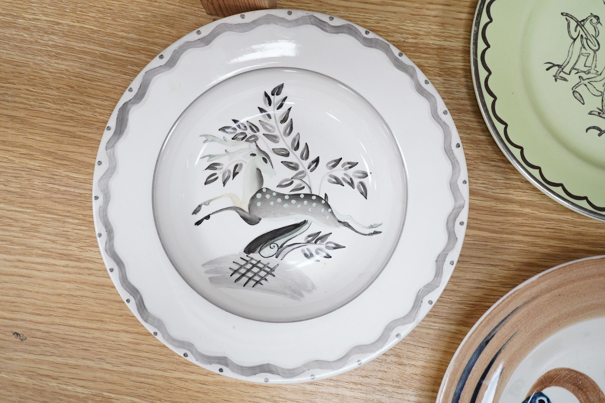 A Billie Waters Clarice Cliff Bizarre bowl, John Armstrong Bizarre bowl and an Ernest Proctor plate, 23cm in diameter